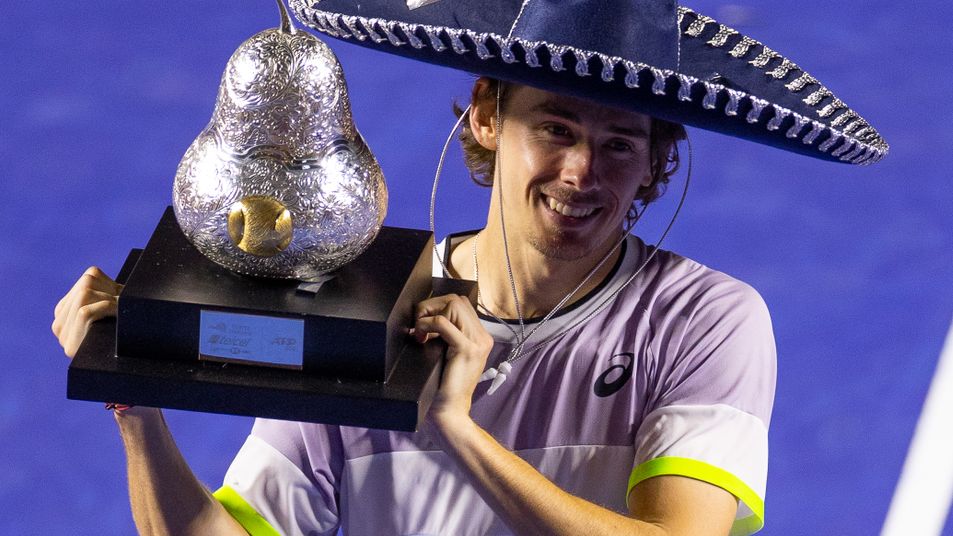 Alex de Minaur poses with the champion trophy after winning the Mexican Open.