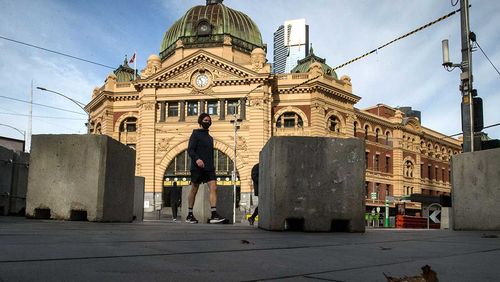 The normally busy intersection of Flinders and Swanston streets outside Flinders Street station in Melbourne.