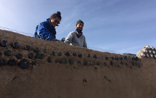 Derrick, left, and Mario, right, from Puerto Rico, learn how to build an Earthship. (9NEWS)