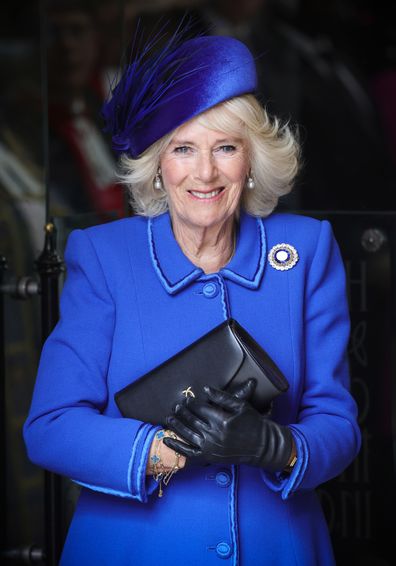 Camilla, Queen Consort smiles as she attends the 2023 Commonwealth Day Service at Westminster Abbey on March 13, 2023 in London, England, wearing the Russian sapphire brooch.