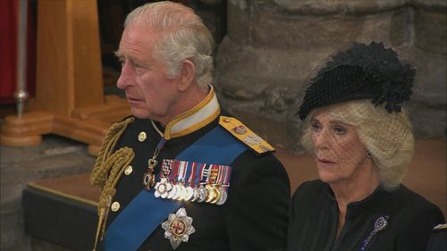 Royal funeral guests wear quiet tributes to the Queen