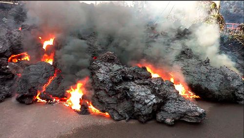 A lava flow advances down a road near Pahoa on the island of Hawaii. Picture: AP