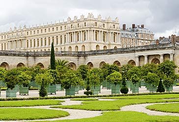 Who expanded Versailles from a lodge to a palace?