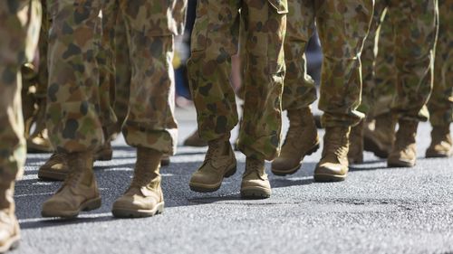 Feet of soldiers marching at an ANZAC Day parade on the streets of a regional country town