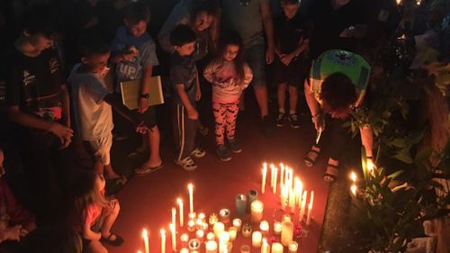 Mourners hold a candlelight vigil for the victims. (Facebook)
