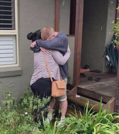 The moment the couple reunited after being cut-off by flood waters for three days. 