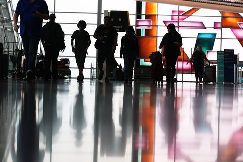 A flight is listed as cancelled on a display at San Diego International Airport Saturday, Nov. 8, 2025, in San Diego. (AP Photo/Gregory Bull)
