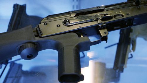 A device called a "bump stock" is attached to a semi-automatic rifle. (AAP)