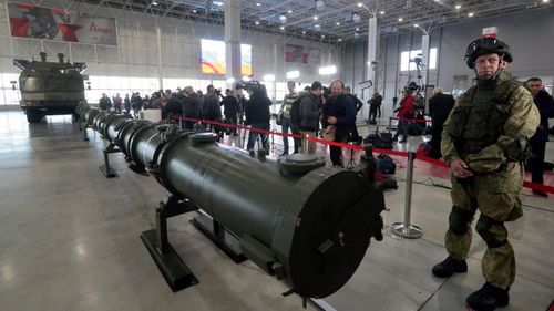 Military serviceman stands near missile complex