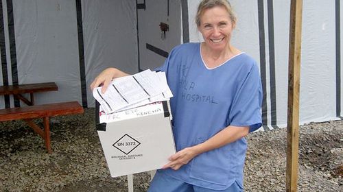 "Scary moment but went smoothly. A pivotal moment for sure in my career xx," Sue Ellen Kovack wrote under this photo of her holding blood samples of an 11-year-old who was hoped to be her Ebola centre's "first Ebola survivor". (Facebook)