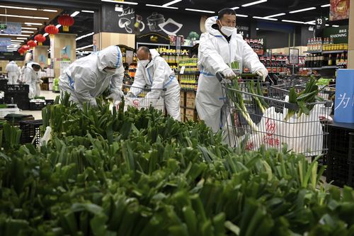 In this photo released by Xinhua News Agency, a workers prepare bags of groceries to be delivered to households under closed-off management in Xi'an, in northwestern China's Shaanxi Province, Dec. 29, 2021. Chinese officials promised steady deliveries of groceries to residents of Xian, an ancient capital with 13 million people that is under the strictest lockdown of a major Chinese city since Wuhan was shut early last year at the start of the pandemic. (Liu Xiao/Xinhua via AP)