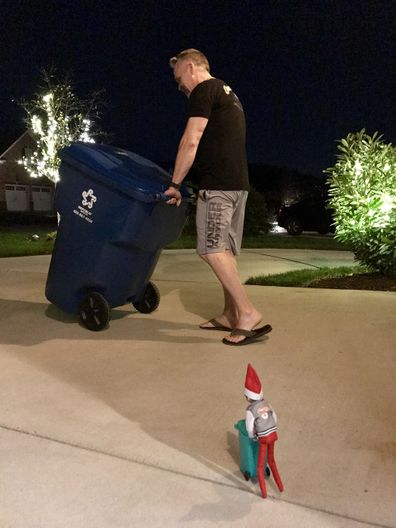 Elf on the Shelf taking out the rubbish.