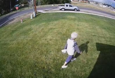 Woman cutting across lawn