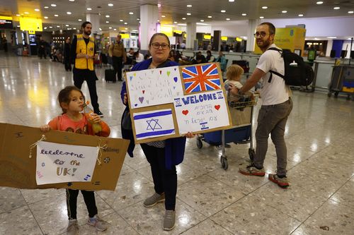 LONDON, ENGLAND - OCTOBER 13: Members of London's Israeli community greet Australian citizens evacuated from Israel, at Terminal 3, Heathrow on October 13, 2023 in London, England. 238 Australian nationals are on the flight  to London Heathrow following the Hamas surprise attack on Israel last Saturday left 1300 dead and as many as 150 people were taken hostage and moved to Gaza.  (Photo by Peter Nicholls/Getty Images)