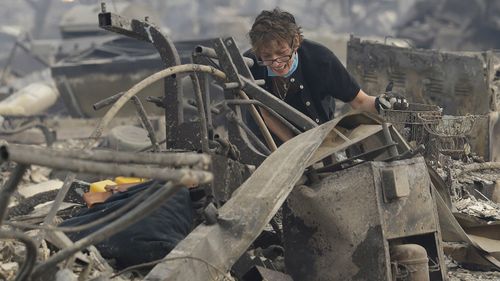 Kristine Pond reacts as she searches the remains of her family's home destroyed by fires in Santa Rosa, Calif. (AP)