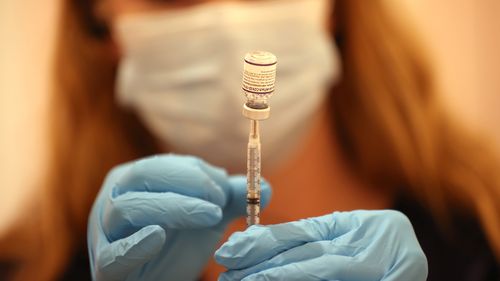 Safeway pharmacist Ashley McGee fills a syringe with the Pfizer COVID-19 booster vaccination at a vaccination booster shot clinic on October 01, 2021 in San Rafael, California. 