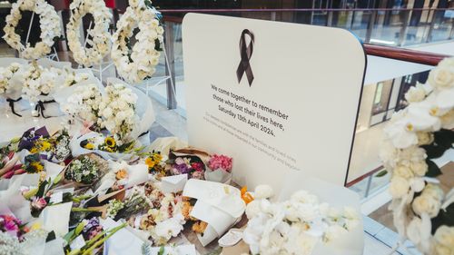 Flowers and gifts are laid at the Westfield Bondi Junction shopping centre 