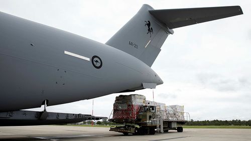 Air Force Air Movements Operators from No. 23 Squadron load humantarian assistance supplies bound for Tonga onto a C-17A Globemaster III strategic transport aircraft at RAAF Base Amberley.