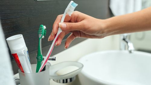 Woman holding toothbrush