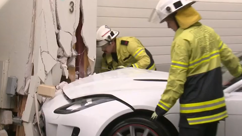 Man crashes luxury Jaguar into front of neighbour's home