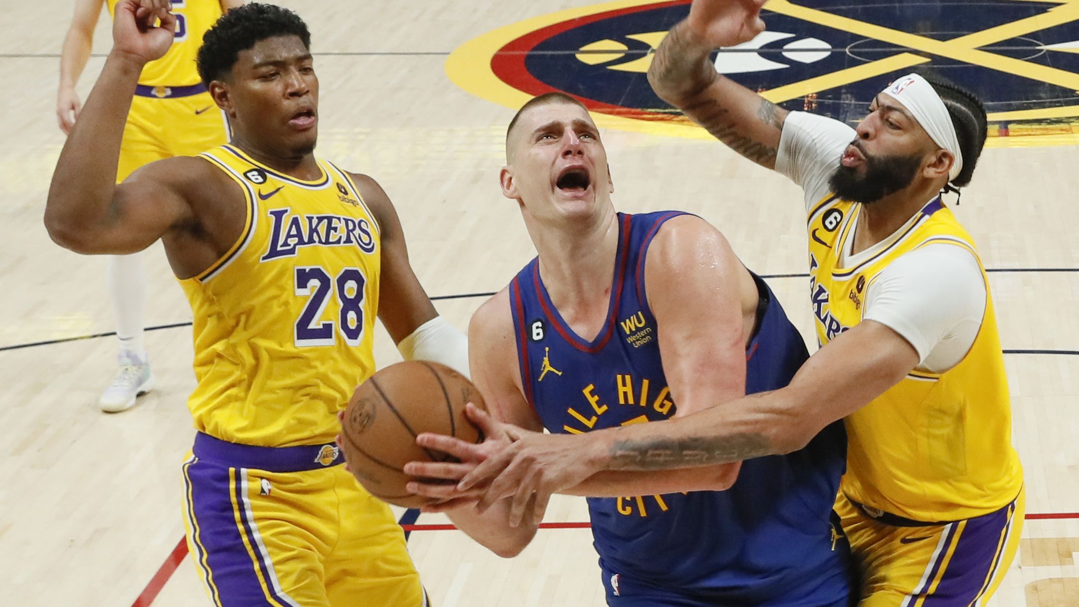 Denver, CO, Tuesday, May 16, 2023 - Denver Nuggets center Nikola Jokic (15) is fouled by Los Angeles Lakers forward Anthony Davis (3) late in the game, giving him two free throws and a five point lead with 26 seconds remaining in game one of the NBA Western Conference Finals at Ball Arena.  (Robert Gauthier/Los Angeles Times via Getty Images)