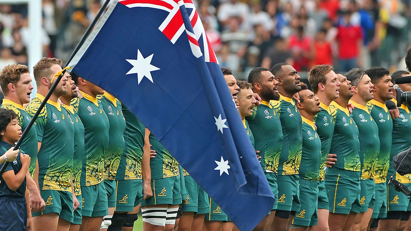 Australian players line up for the national anthem