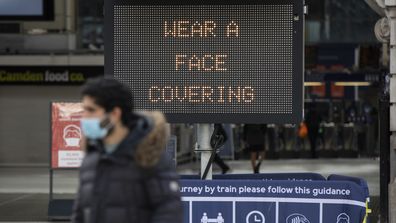  People walk past a sign telling to wear a face mask on October 15, 2020 in London, England. 
