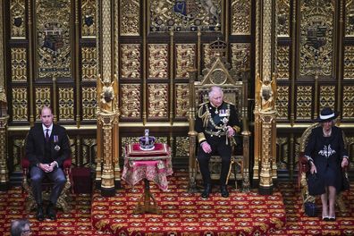 Prince Charles, Prince of Wales (2nd R) sits by the The Imperial State Crown (2nd L) with Britain's Prince William, Duke of Cambridge (L) and Britain's Camilla, Duchess of Cornwall (R) in the House of Lords Chamber, during the State Opening of Parliament, in the Houses of Parliament, in London, on May 10, 2022.