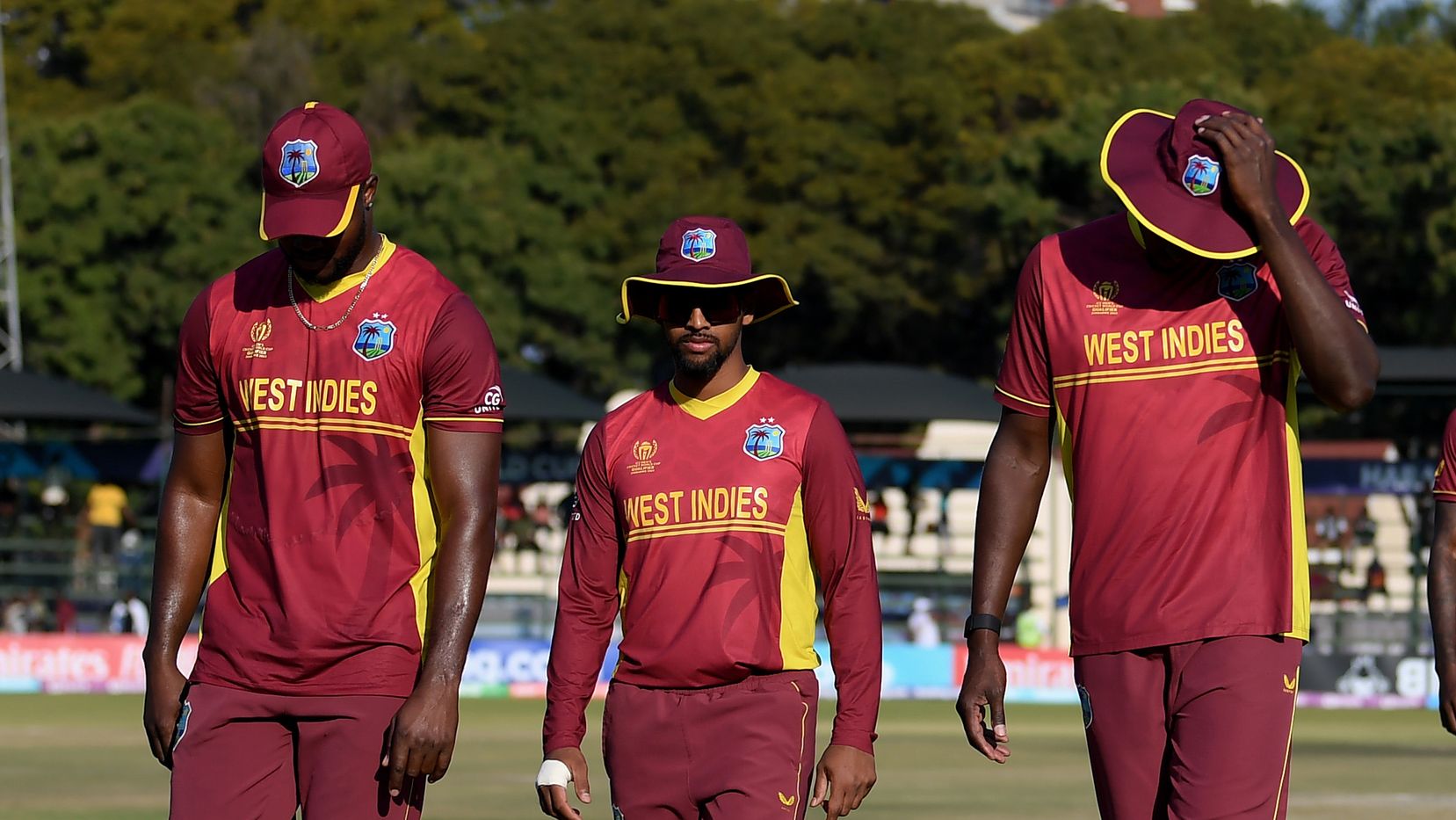 West Indies players walk off the field after being defeated by Scotland.