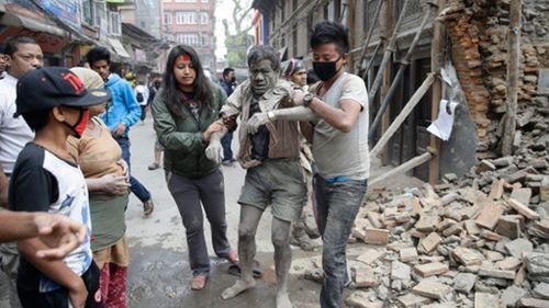 People dig through the rubble of collapsed buildings and search for survivors. (AAP)