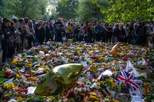 LONDON, ENGLAND - SEPTEMBER 18: People view flowers and tributes to Queen Elizabeth II in Green Park on September 18, 2022 in London, United Kingdom. Queen Elizabeth II is lying in state at Westminster Hall until the morning of her funeral to allow members of the public to pay their last respects. Elizabeth Alexandra Mary Windsor was born in Bruton Street, Mayfair, London on 21 April 1926. She married Prince Philip in 1947 and acceded to the throne of the United Kingdom and Commonwealth on 6 Feb