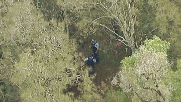 Police are working to retrieve the woman's body. (9NEWS)