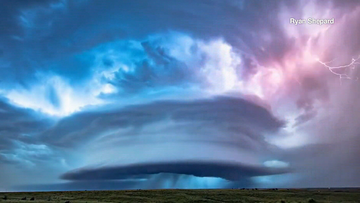 Time-lapse footage shows the supercell hovering over corn fields in Kansas.