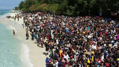 Thousands of people wait to get off the Gili Islands. Picture: AAP