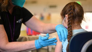 A nurse administers a pediatric dose of the Covid-19 vaccine to a girl at a L.A. Care Health Plan vaccination clinic at Los Angeles Mission College in the Sylmar neighborhood in Los Angeles, California, January 19, 2022 