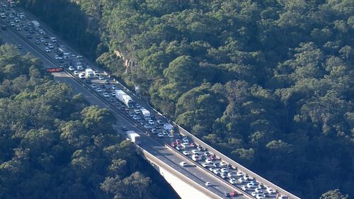 Long lines of traffic heading south snake back from the truck.