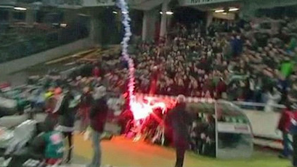 A flare hits the Hannover dugout during their Bundeliga clash with Wolfsburg. (Supplied)