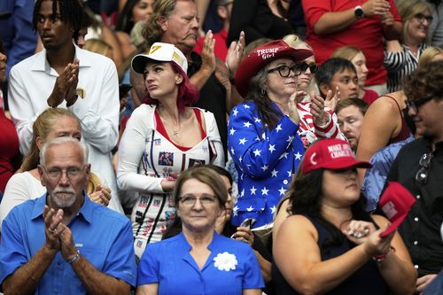 People attend a memorial for conservative activist Charlie Kirk.