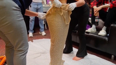 Kim Kardashian tries to fit into Marilyn Monroe's 'Happy Birthday, Mr President' dress.