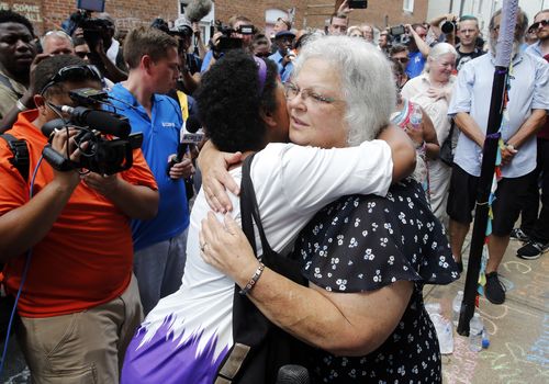 Mrs Bro is hugged by a well-wisher in Charlottesville. Picture: AP