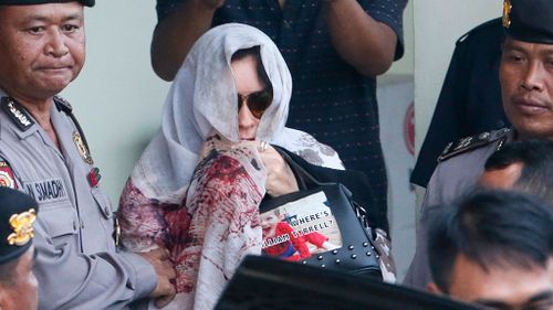 Schapelle Corby carried the William Tyrrell handbag and covered herself with a shawl. (AAP)