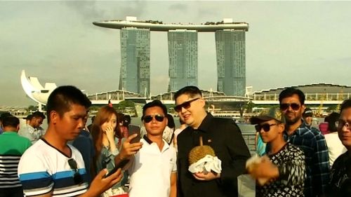 Howard stops and poses for photos in Singapore. Picture: 9NEWS