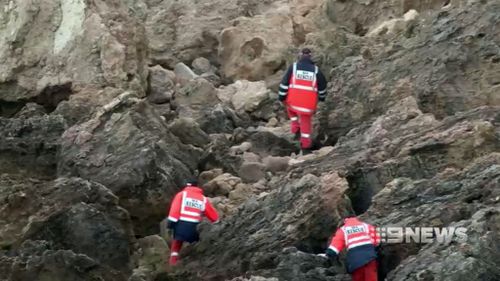 Rescue workers scale rocks looking for Mr Green