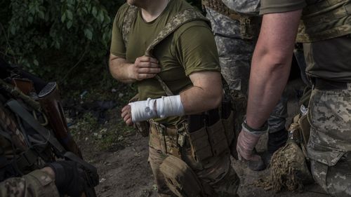serviceman is evacuated to an aid station in a town near the frontline in Donetsk oblast region, eastern Ukraine, Sunday, June 5, 2022. (AP Photo/Bernat Armangue)