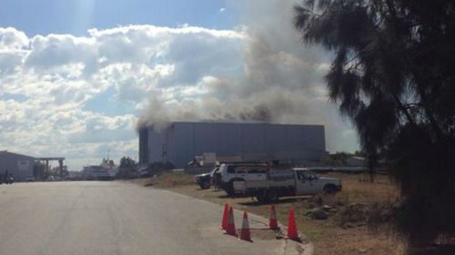 A ship and shed are on fire at a Brisbane shipyard.