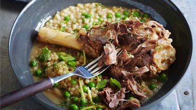 Braised lamb shanks with pearl cous cous, peas and mint
