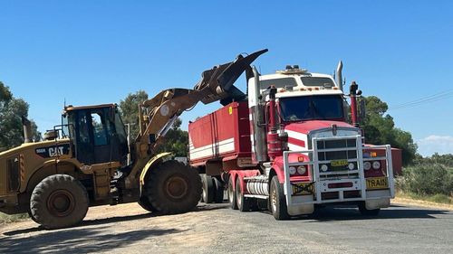 NSW Police clear dead fish from Main Weir Pool in Menindee.