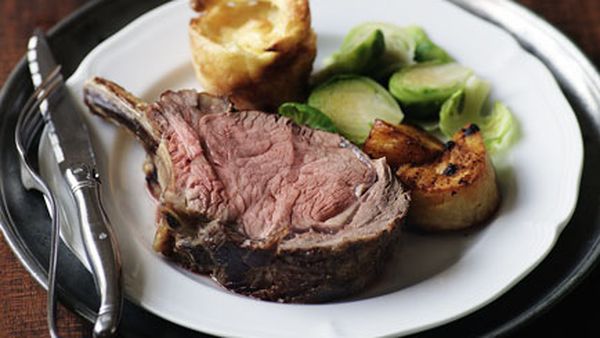 Prime rib of beef with Yorkshire puddings, roast potatoes and Brussels sprouts