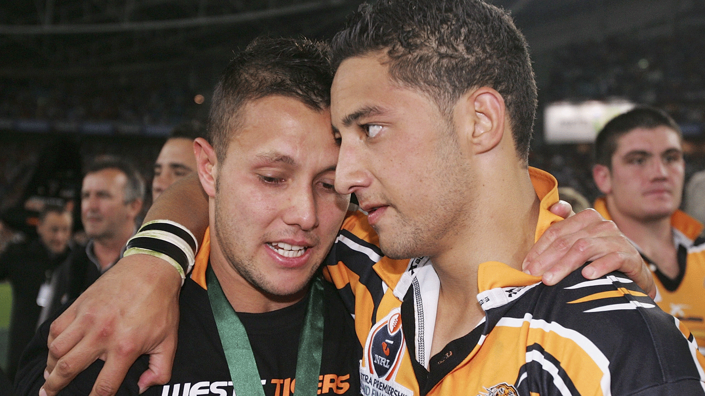 Scott Prince and Benji Marshall share a moment after winning the 2005 NRL grand final.