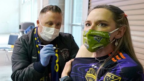 A soccer fan gets a Moderna vaccine ahead of an MLS game in Seattle.